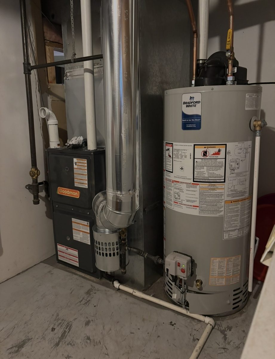 Goodman gas furnace and Bradford White gas water heater installed side by side with metal venting and ductwork